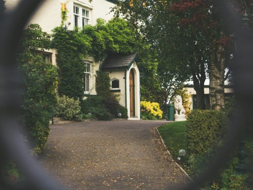 minimalist photography of house shot in front of chain fence