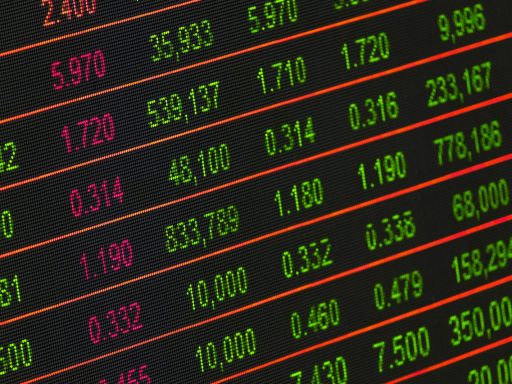 Close-up of a digital stock market data display showing colorful financial numbers and trends.