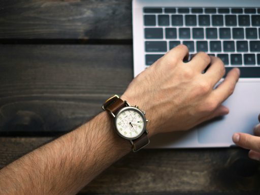 person wearing brown and white watch