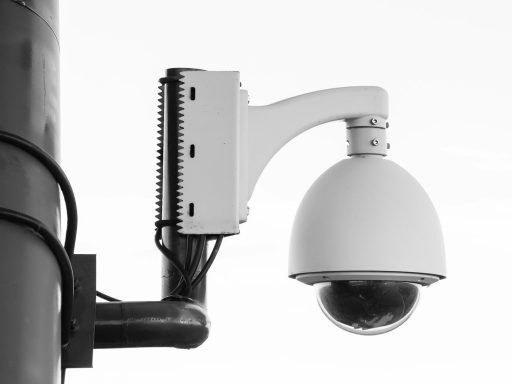 white security camera on post